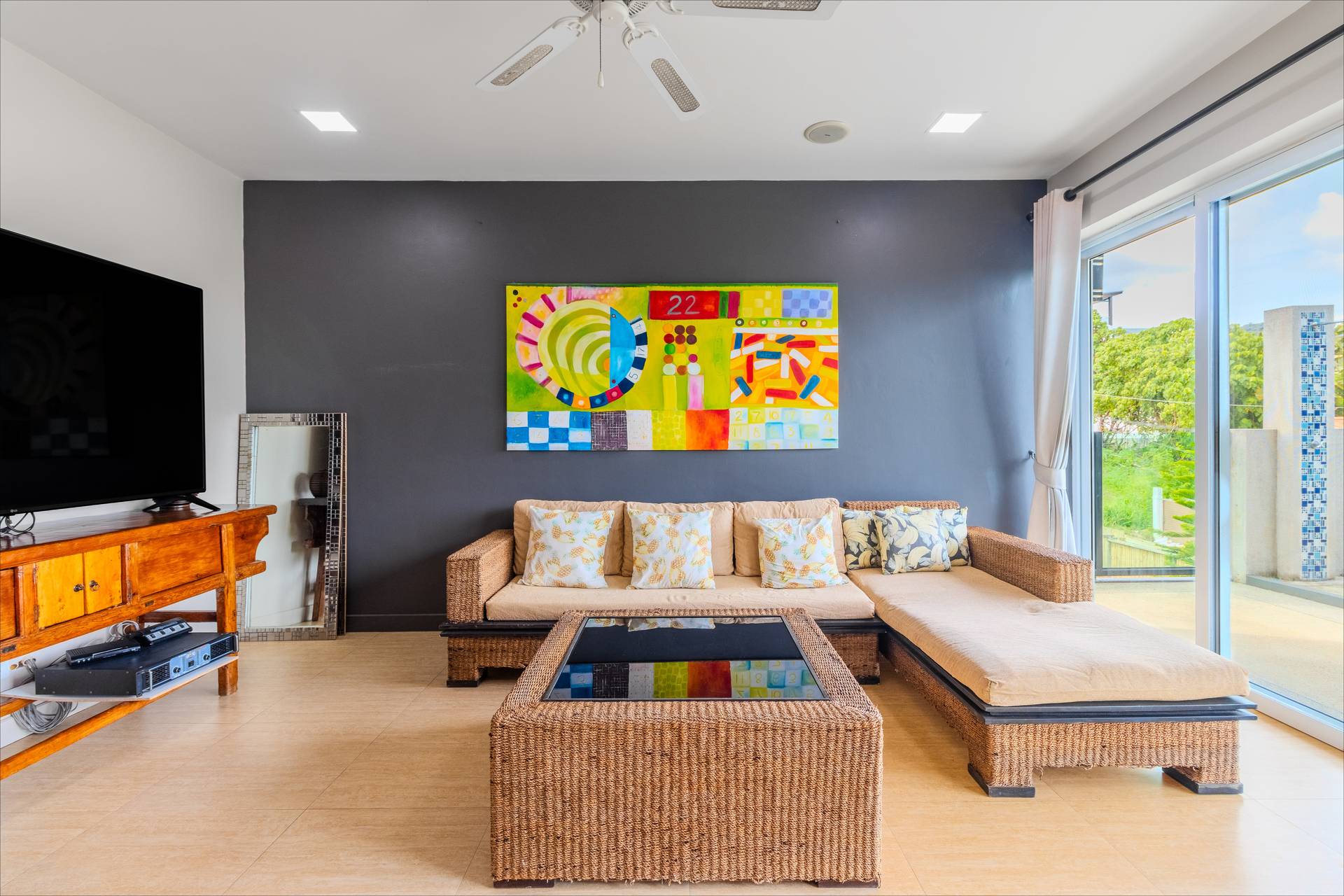 Open-plan living room with contemporary Thai decor and comfortable seating at the Rawai estate