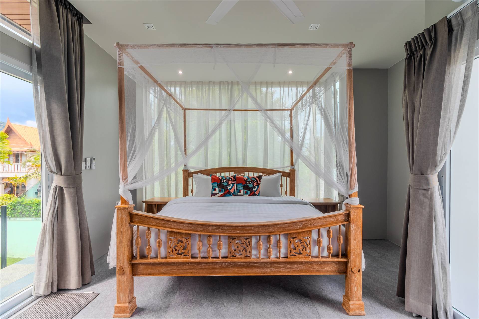 Elegant en-suite bedroom with tropical garden views and contemporary furnishings