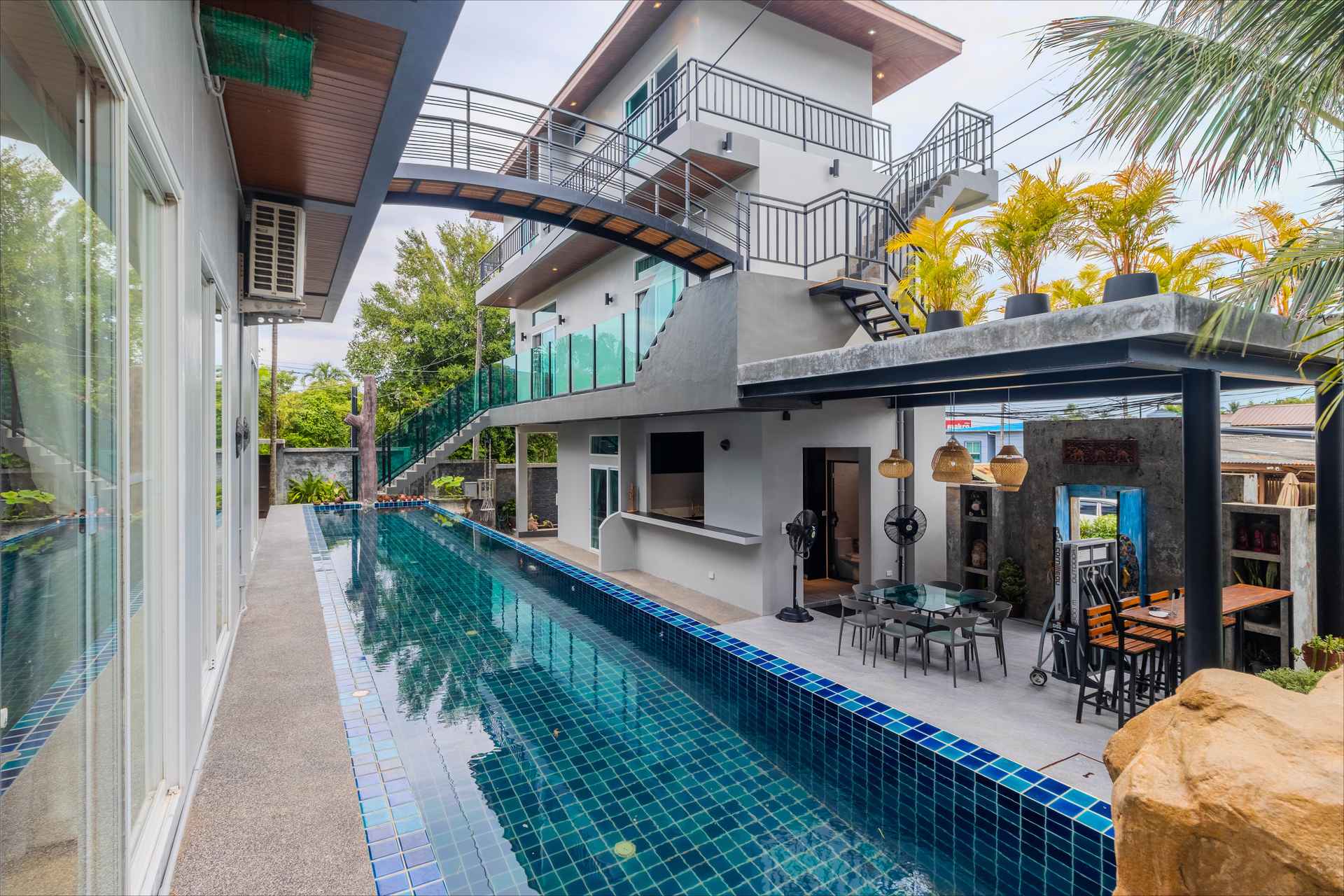 Infinity-edge pool overlooking tropical gardens at the luxury Rawai estate